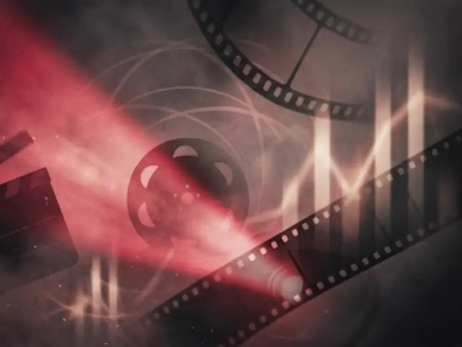 Illustrated film strip, clapperboard and cinema seats with a projector light cone through haze
